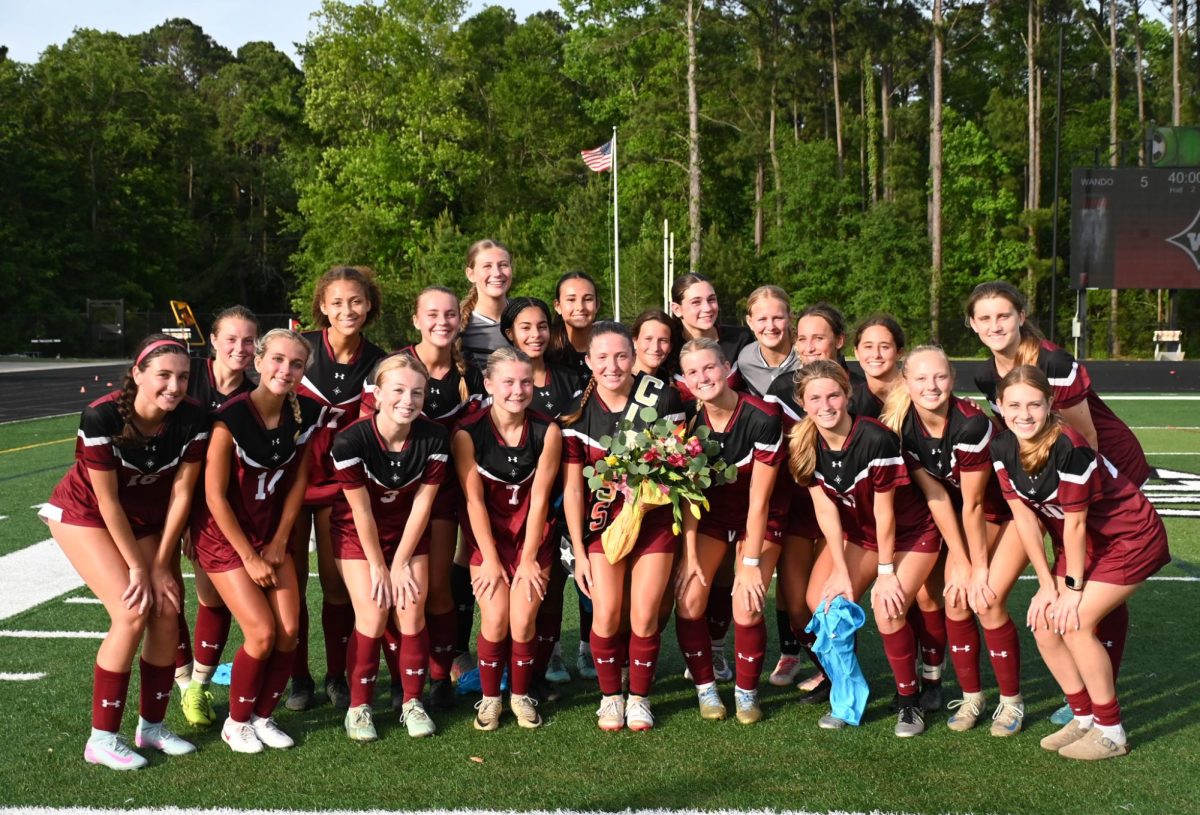 The whole team poses for a photo to celebrate Senior Midfielder Sarah DiMinico.